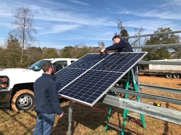 OneWorld Solar crew installing a ground mount solar array