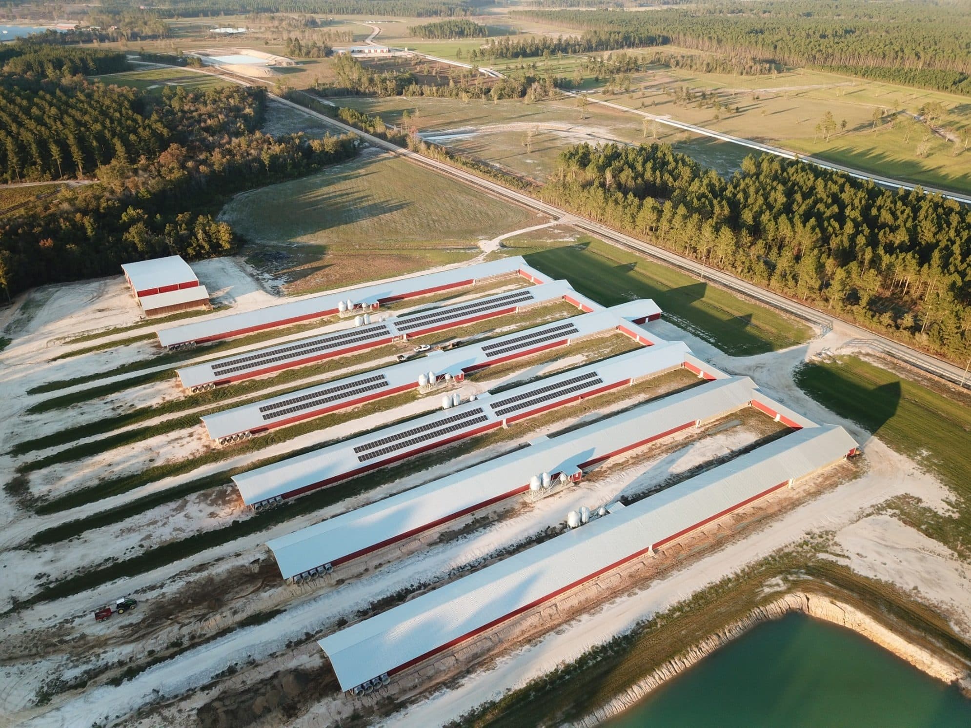 Aerial view of solar panels installed on poultry house roofs on a farm in the Southeast