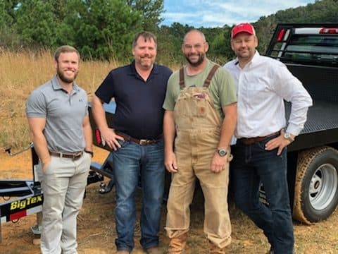 The OneWorld Solar team photographed at the site of the donated 10 kW solar array